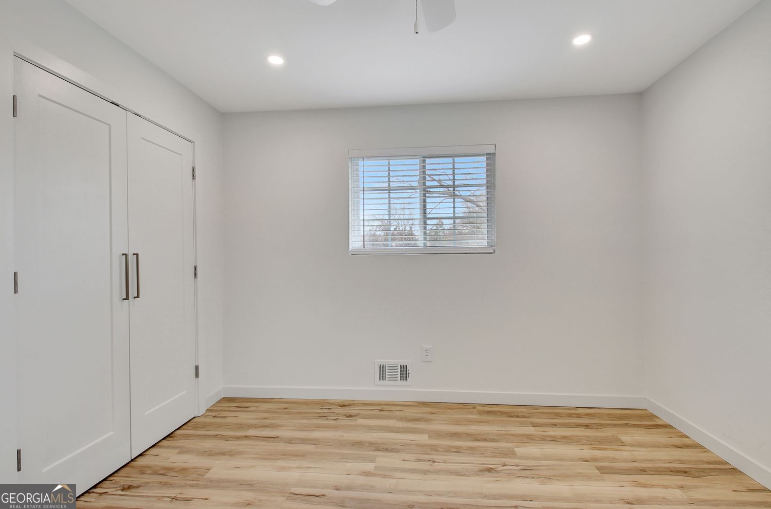 183 Pine Street Northeast Fairburn, GA 30213 - Photo 53 of 68 a view of an empty room with wooden floor and a window