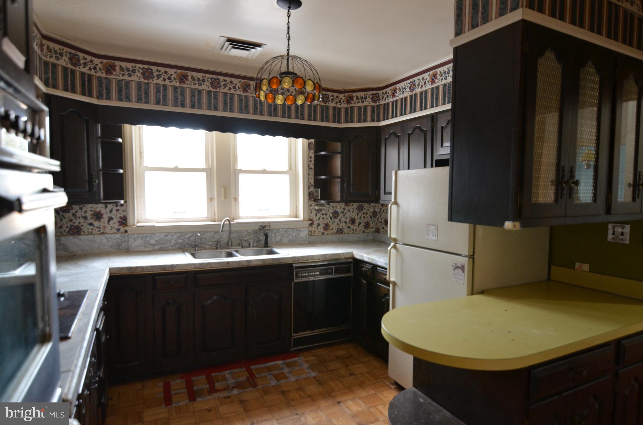 206 Shaw Avenue Silver Spring, MD 20904 - Photo 16 of 35 a kitchen that has a sink a window and a table in it