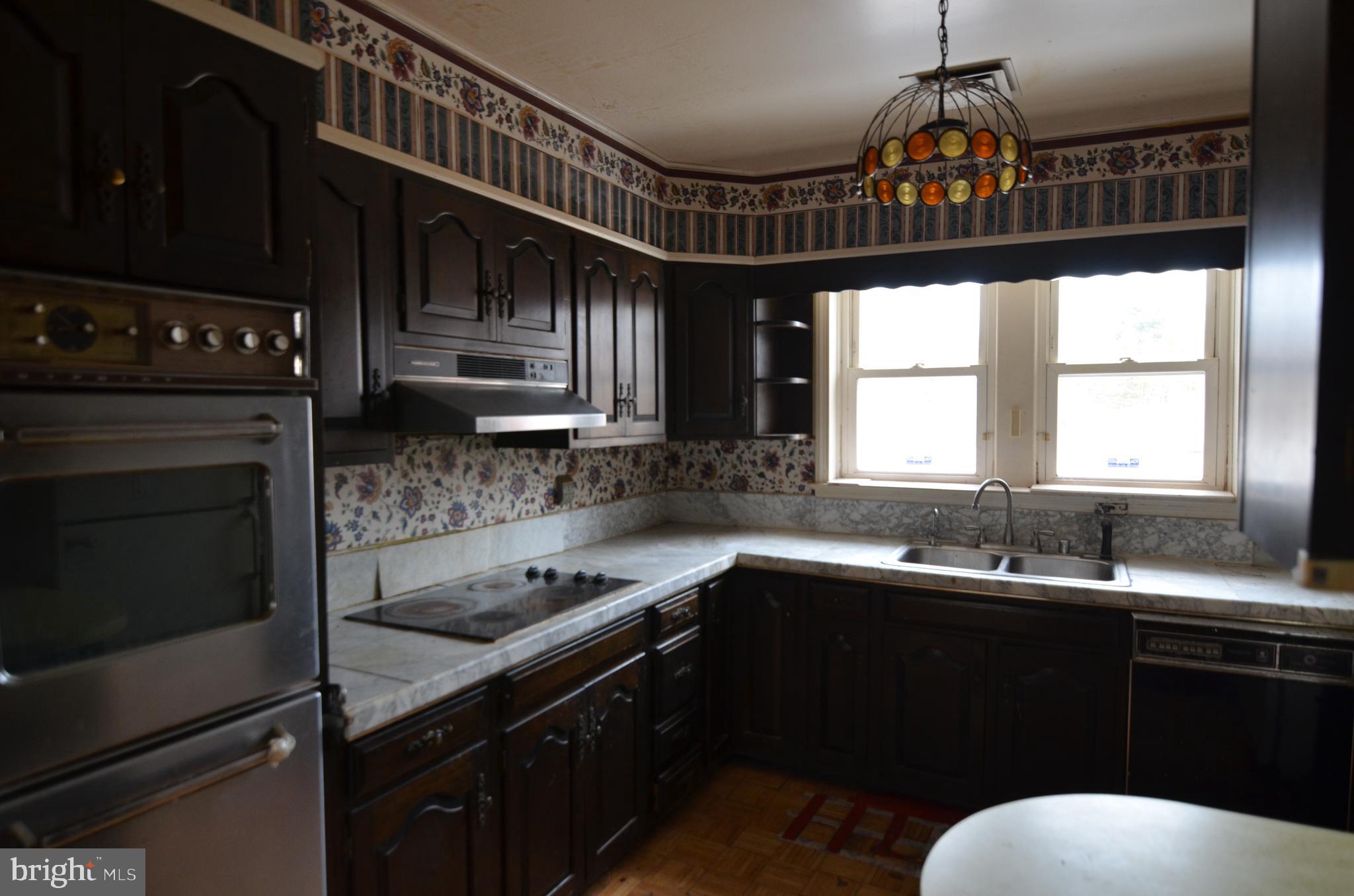 206 Shaw Avenue Silver Spring, MD 20904 - Photo 17 of 35 a kitchen with granite countertop a sink stainless steel appliances and a window