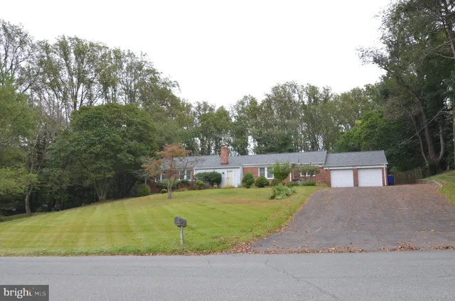 a view of a house with a big yard and potted plants