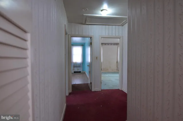 an empty room with a window and wooden floor