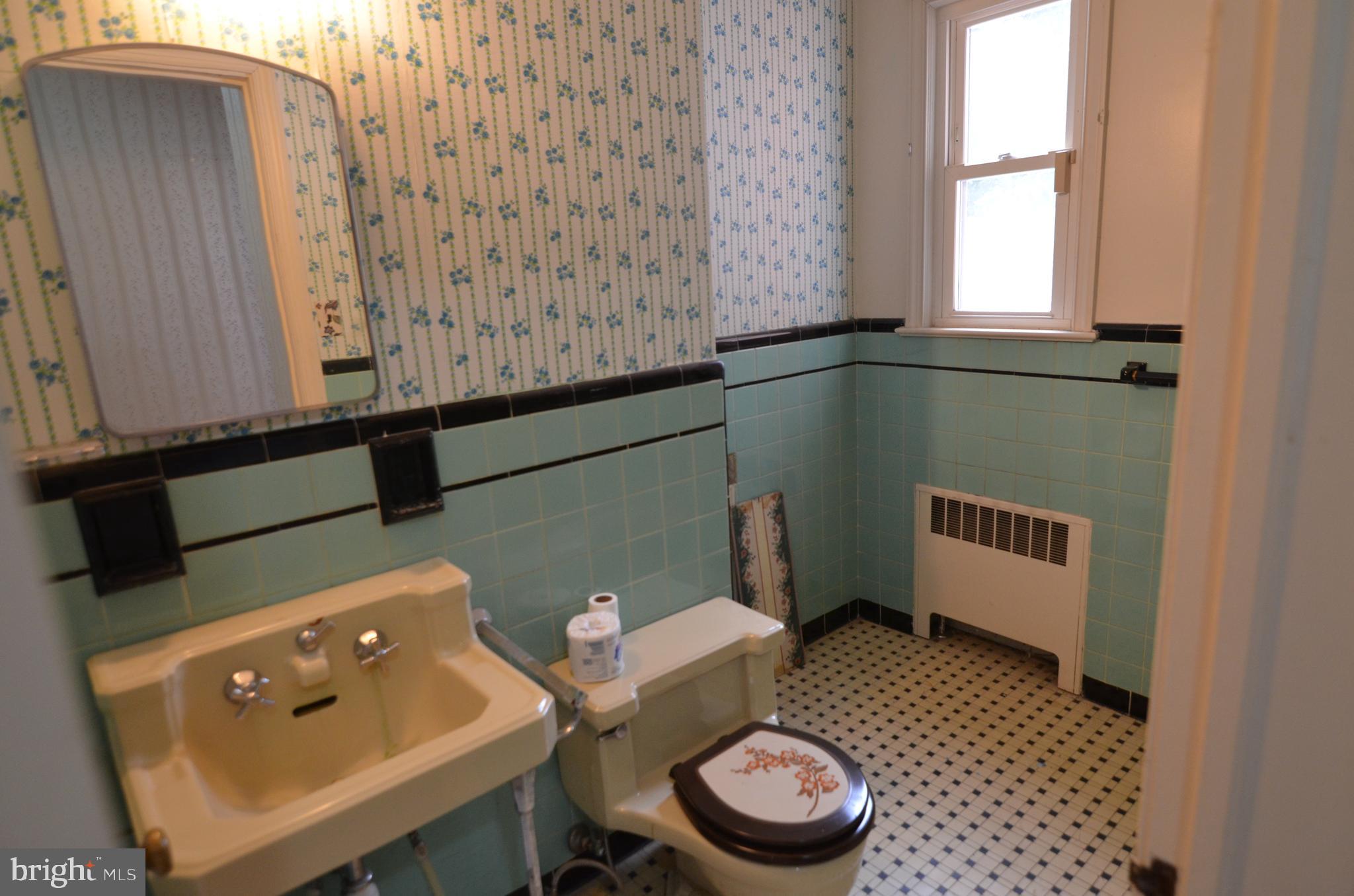 206 Shaw Avenue Silver Spring, MD 20904 - Photo 22 of 35 a bathroom with a toilet a sink and a window