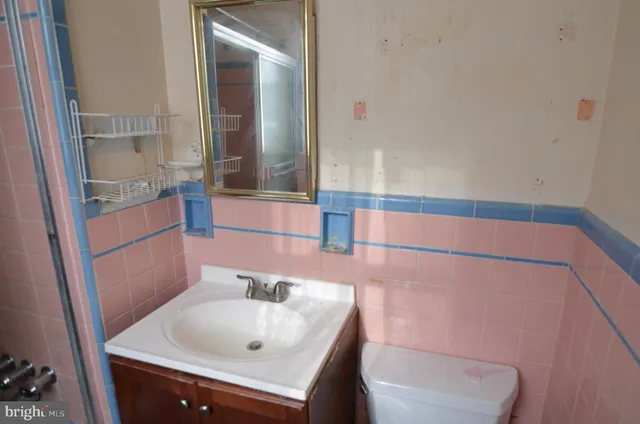 a view of empty room with window and cabinet
