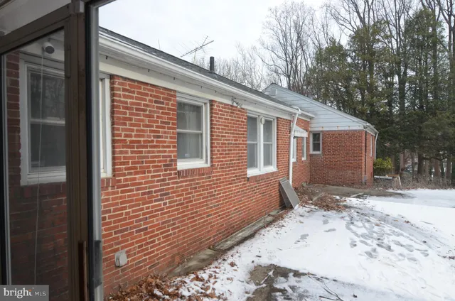 a view of a house with a snow on the road