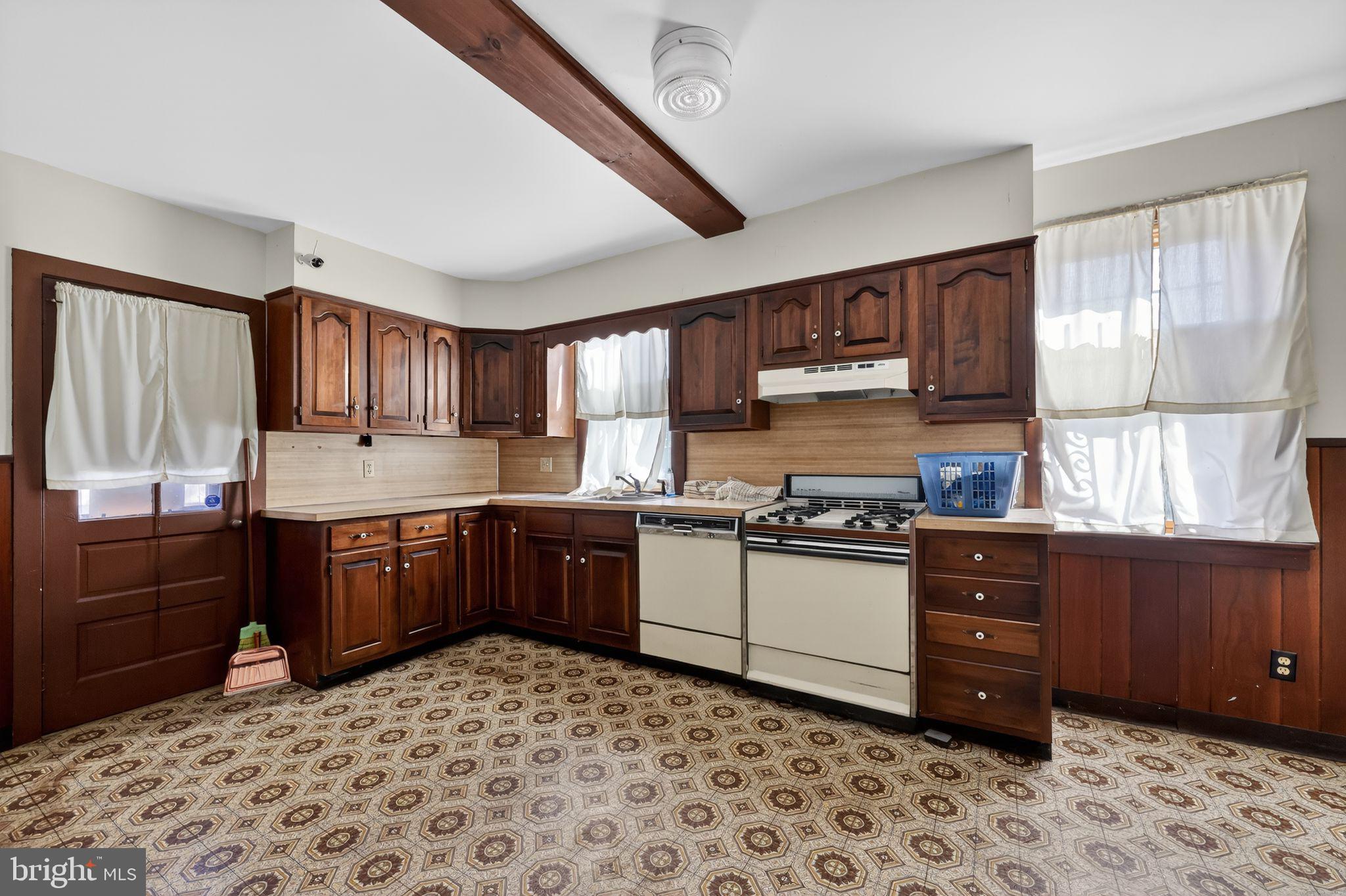 113 South Chestnut Street Ambler, PA 19002 - Photo 16 of 30 a kitchen with granite countertop wooden cabinets and appliances