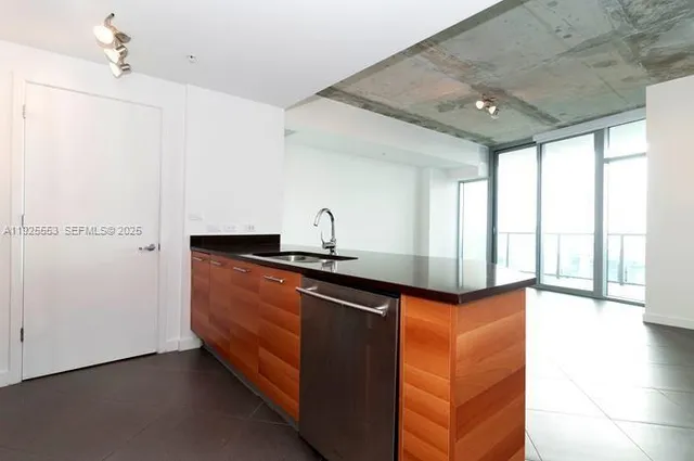 a kitchen with stainless steel appliances granite countertop a sink and a cabinets