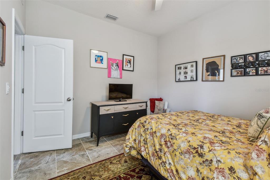 6467 Seasound Drive Apollo Beach, FL 33572 - Photo 11 of 81 a bedroom with a bed and a flat screen tv