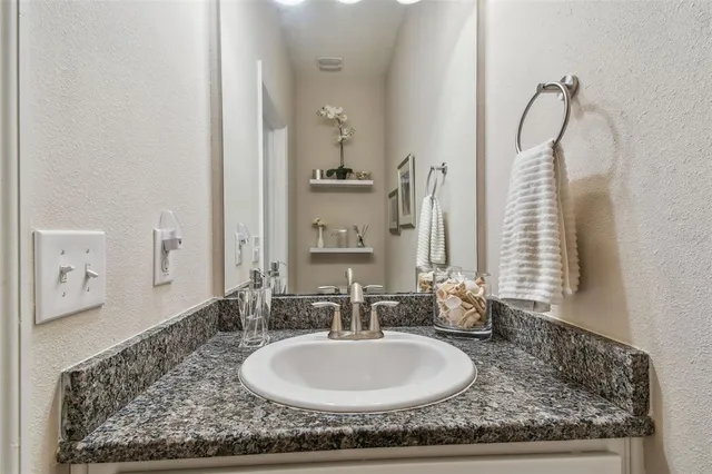 a kitchen with stainless steel appliances granite countertop a sink a stove and cabinets