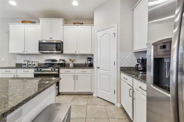 a view of a dining room with furniture and a chandelier