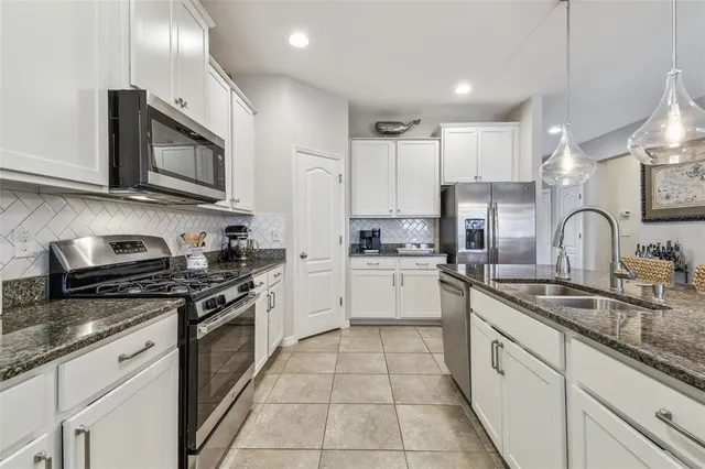 a living room with furniture kitchen and a large window