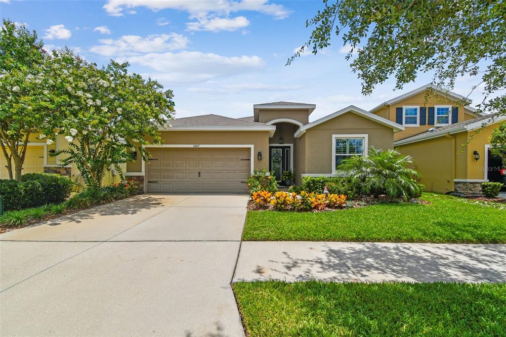 6467 Seasound Drive Apollo Beach, FL 33572 - Photo 3 of 81 a front view of a house with a garden and plants