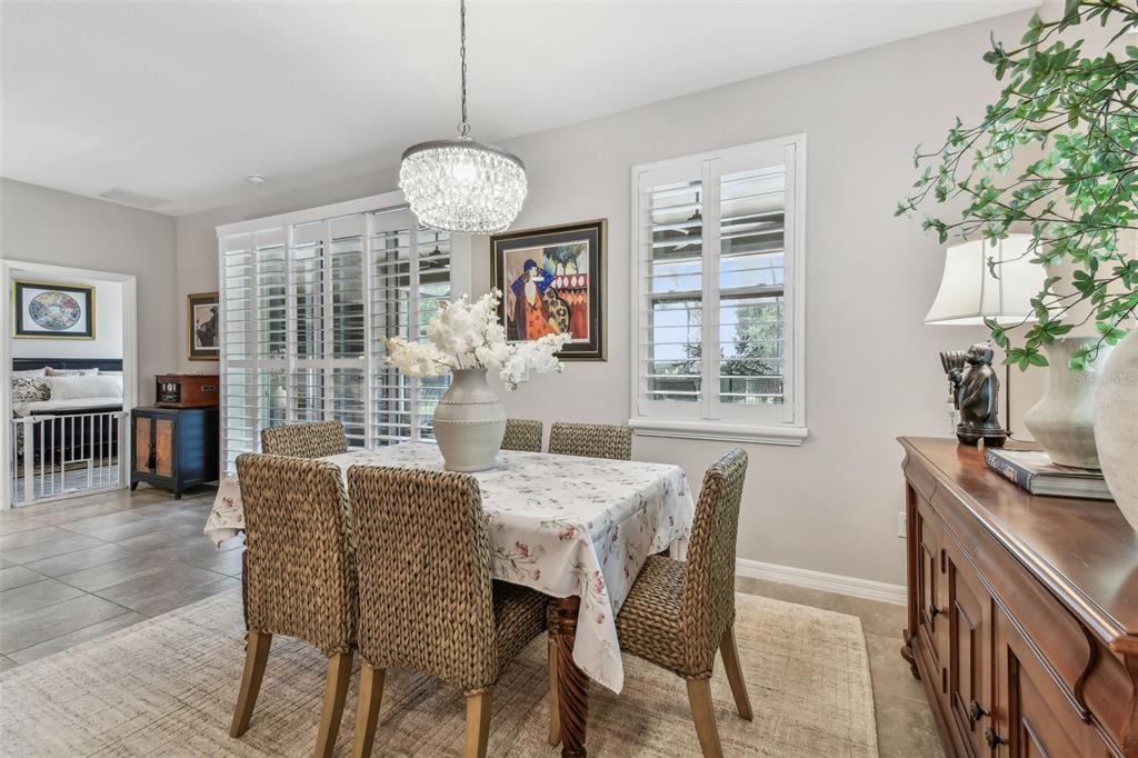 6467 Seasound Drive Apollo Beach, FL 33572 - Photo 32 of 81 a view of a dining room with furniture window and wooden floor