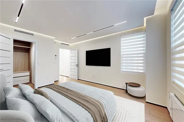 a bedroom with a bed and a television