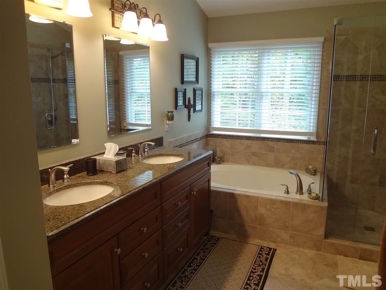 5276 Fairmead Circle Raleigh, NC 27613 - Photo 13 of 25 a bathroom with a tub sink and mirror
