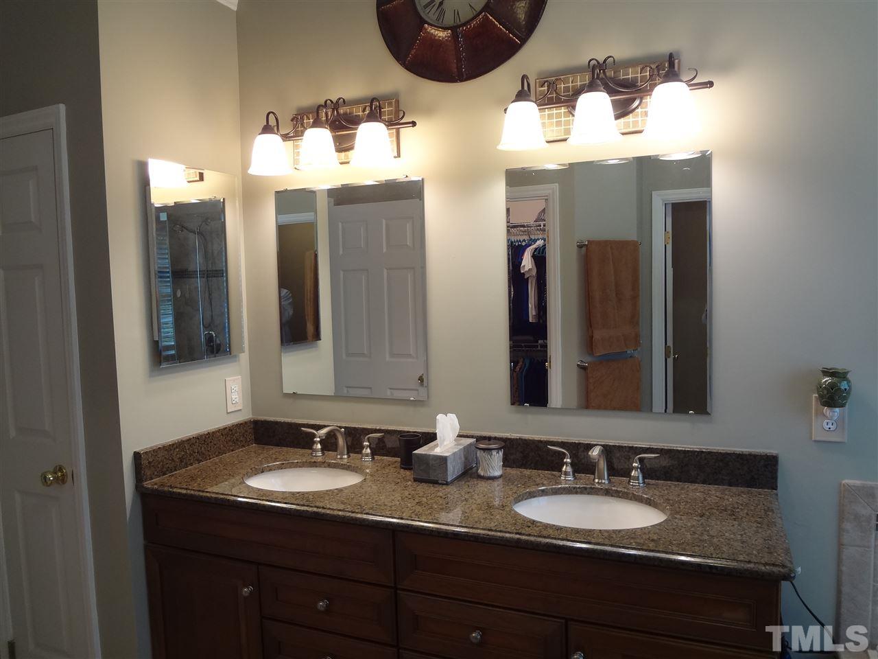 5276 Fairmead Circle Raleigh, NC 27613 - Photo 14 of 25 a bathroom with a granite countertop sink and a mirror