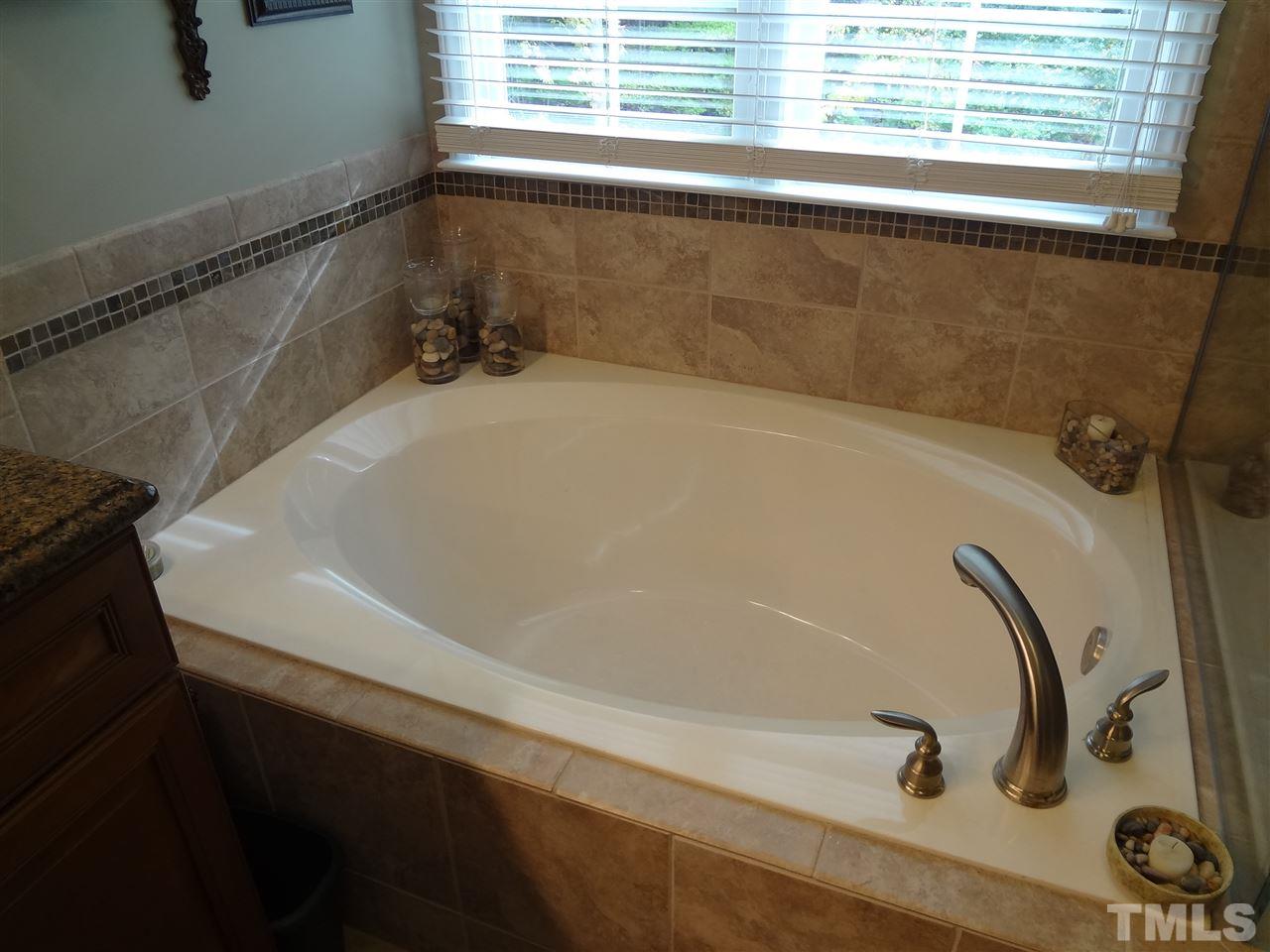 5276 Fairmead Circle Raleigh, NC 27613 - Photo 15 of 25 a bathroom with a bathtub