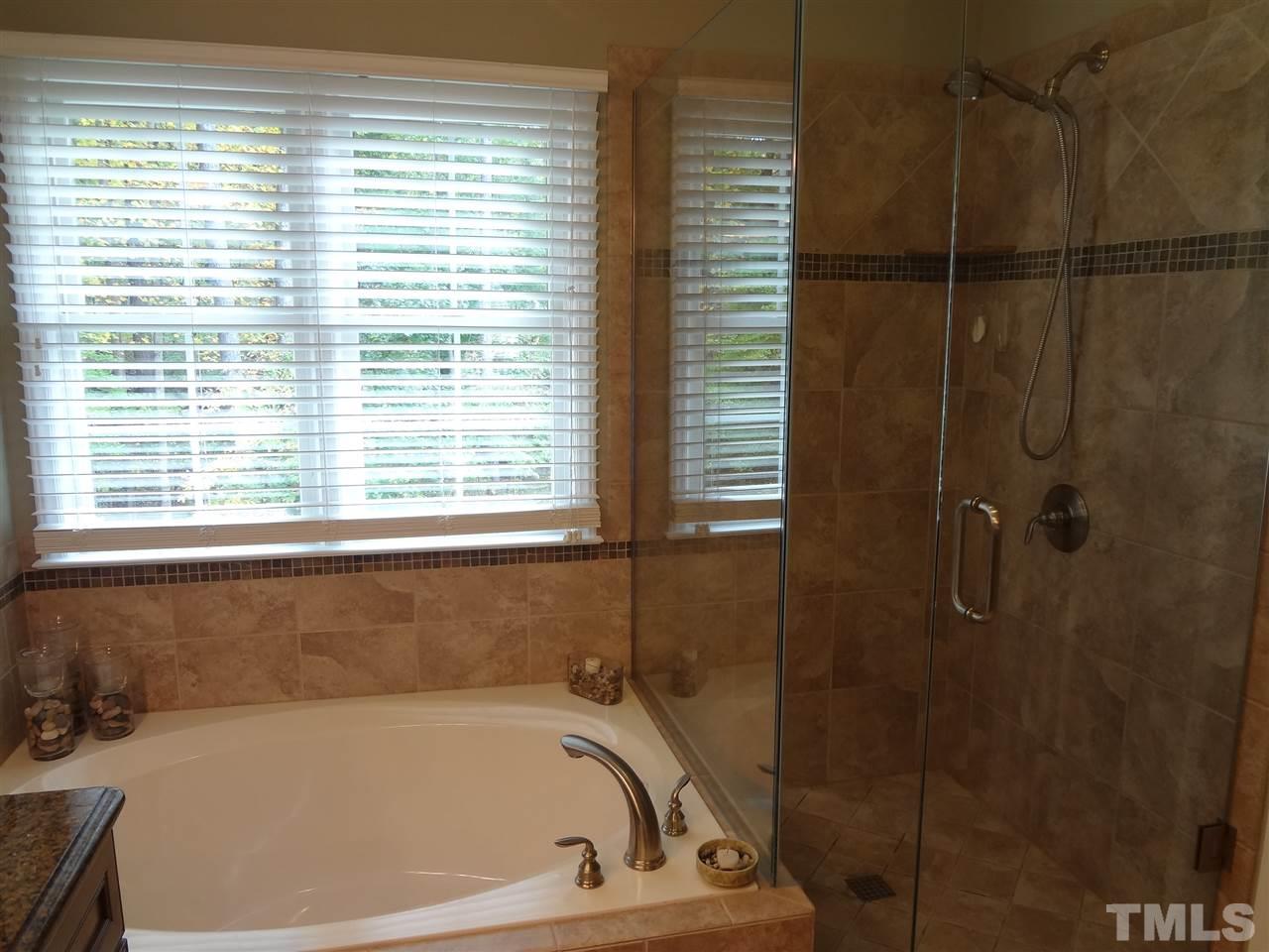 5276 Fairmead Circle Raleigh, NC 27613 - Photo 16 of 25 a bath tub sitting next to a window