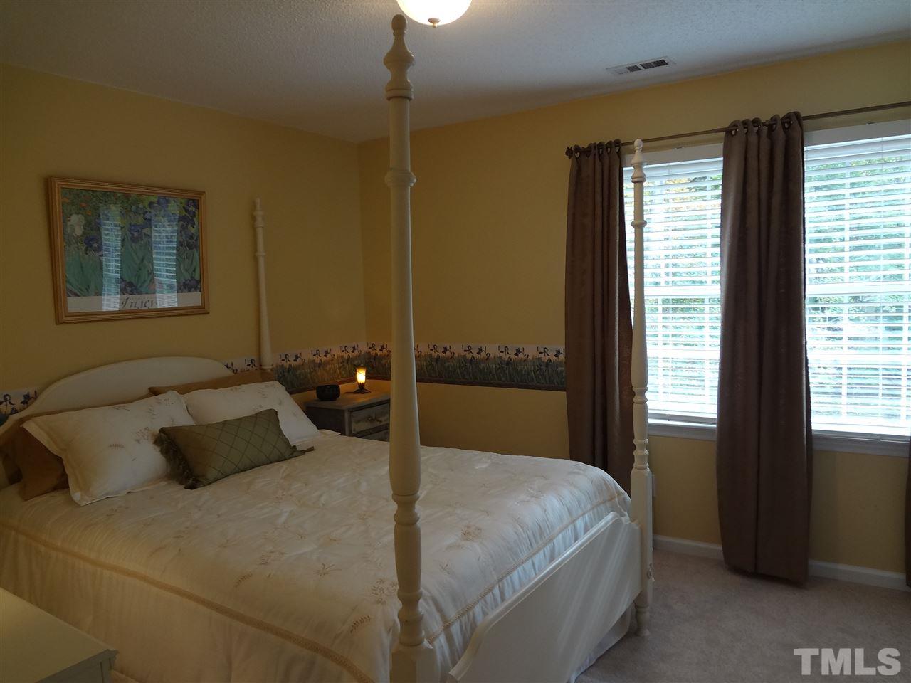 5276 Fairmead Circle Raleigh, NC 27613 - Photo 17 of 25 a bedroom with a bed and window