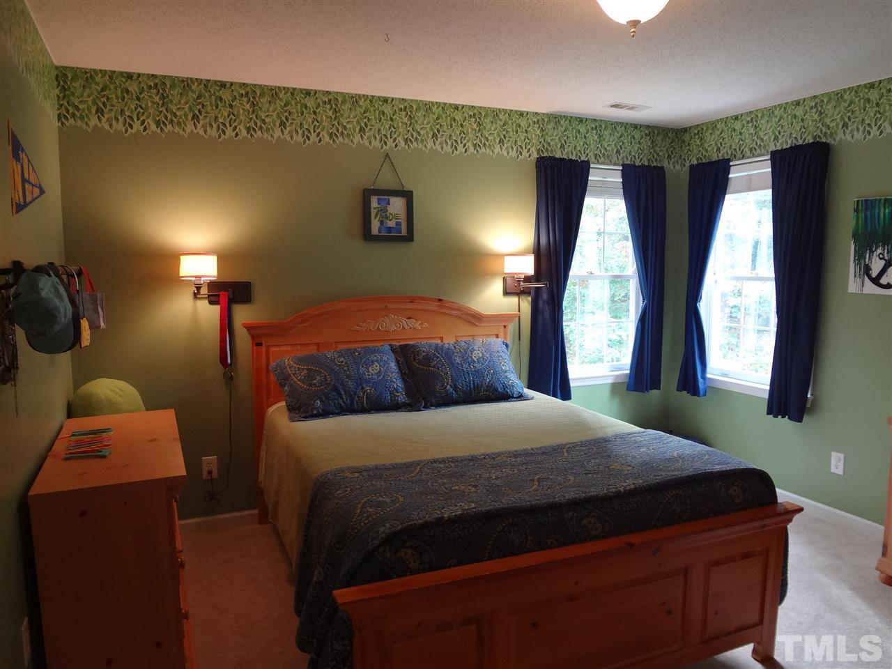 5276 Fairmead Circle Raleigh, NC 27613 - Photo 19 of 25 a bedroom with a bed and window