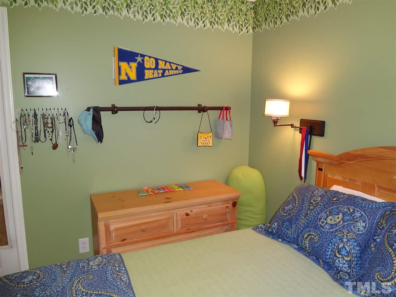 5276 Fairmead Circle Raleigh, NC 27613 - Photo 20 of 25 a bedroom with a bed and a lamp on dresser