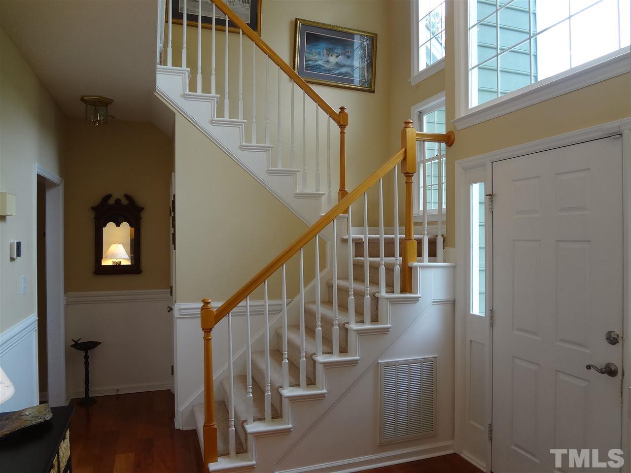5276 Fairmead Circle Raleigh, NC 27613 - Photo 22 of 25 a view of staircase with wooden floor and white walls