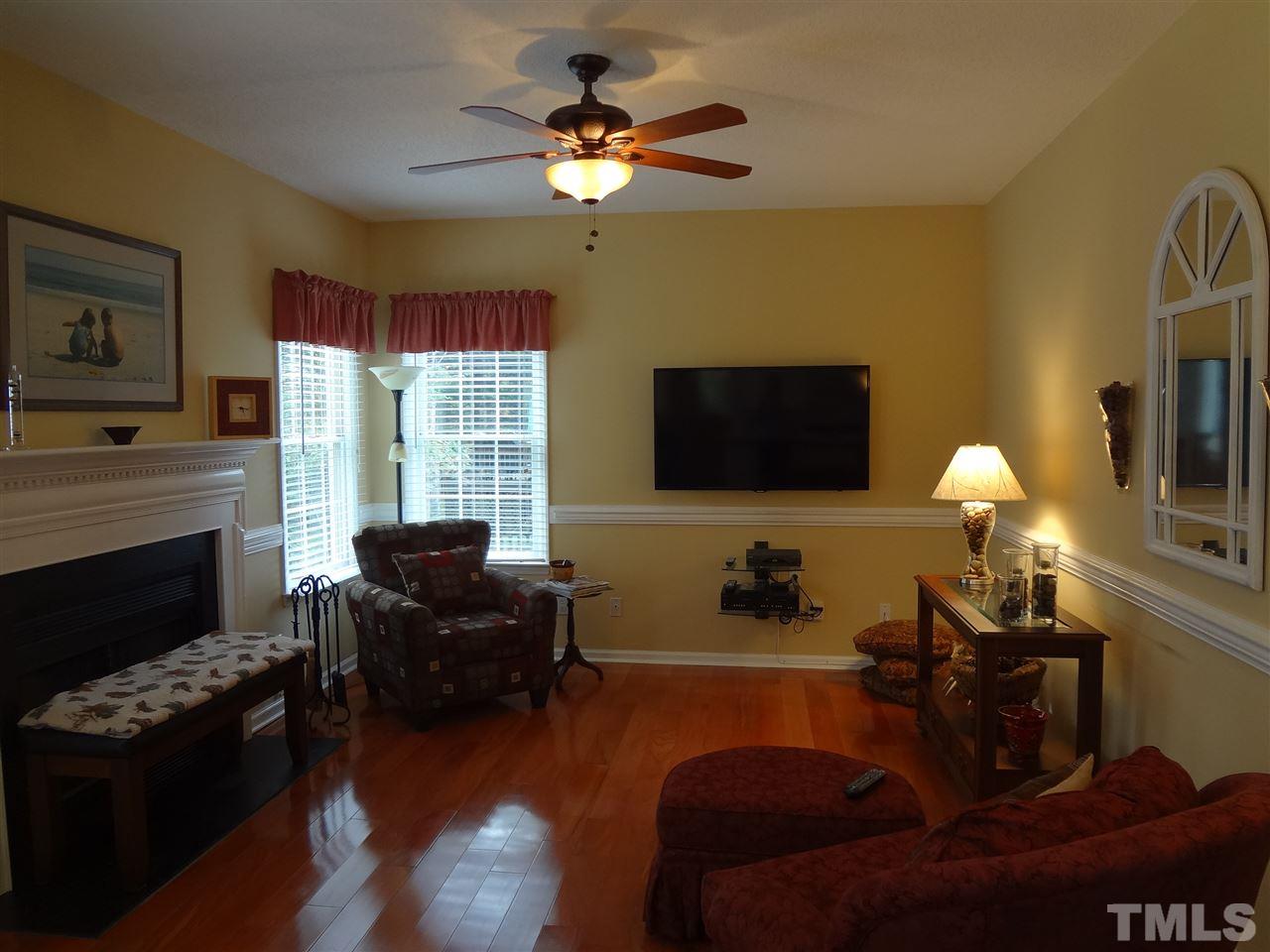 5276 Fairmead Circle Raleigh, NC 27613 - Photo 7 of 25 a living room with furniture fireplace and a flat screen tv