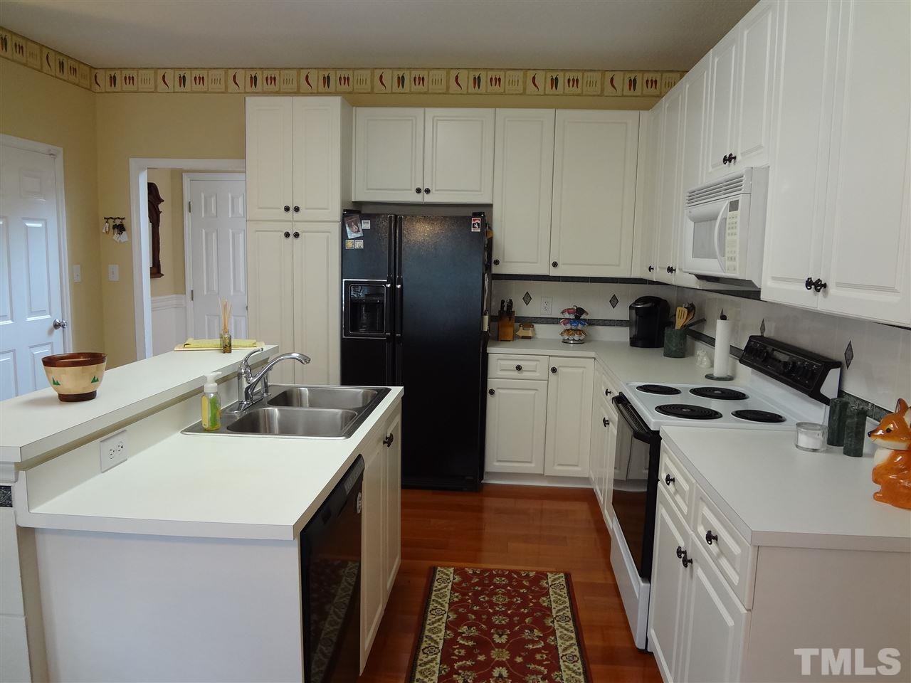 5276 Fairmead Circle Raleigh, NC 27613 - Photo 8 of 25 a kitchen with a sink stove and refrigerator