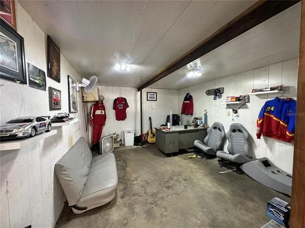 a living room with furniture and a gym equipment