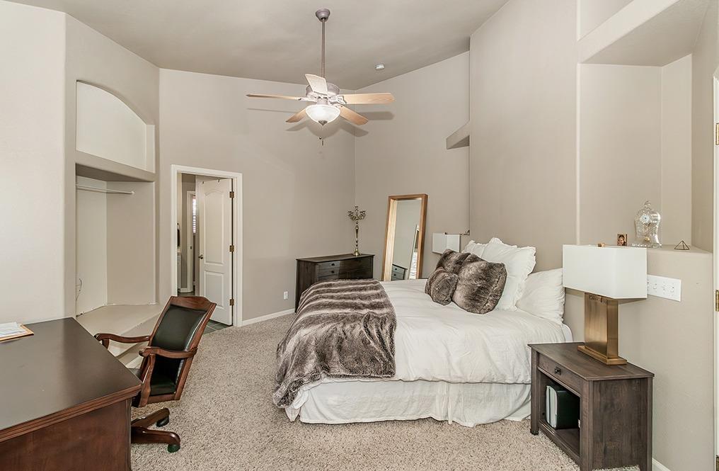 2074 East Revere Road Fresno, CA 93720 - Photo 14 of 39 a bedroom with a bed and a table