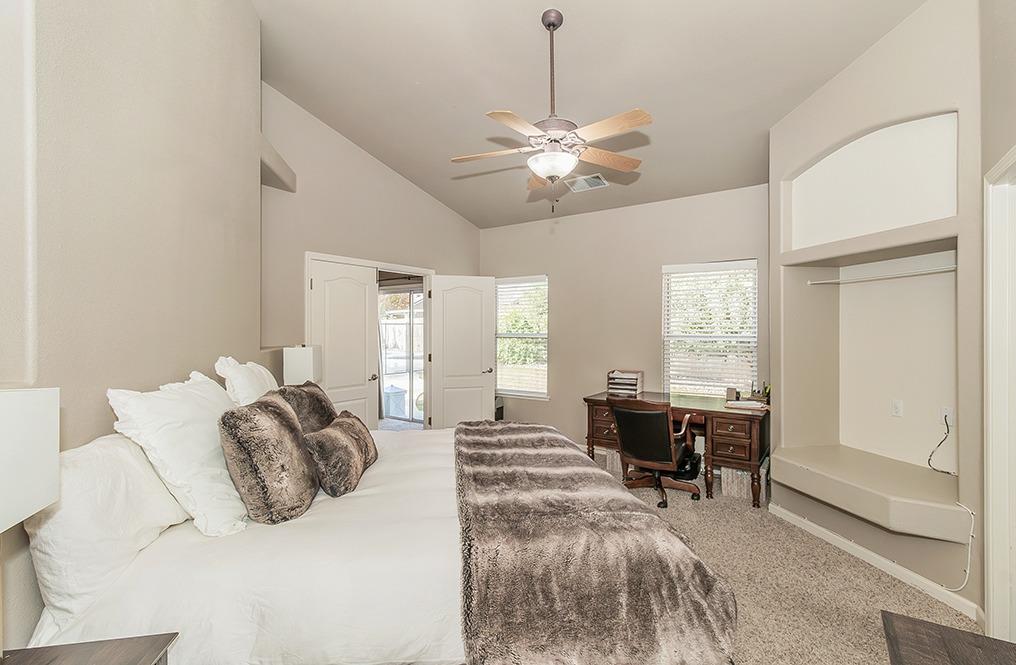 2074 East Revere Road Fresno, CA 93720 - Photo 16 of 39 a bedroom with furniture and a chandelier