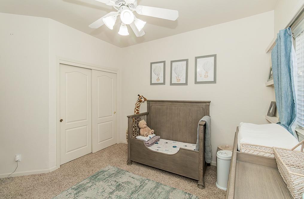 2074 East Revere Road Fresno, CA 93720 - Photo 21 of 39 a living room with furniture and a chandelier
