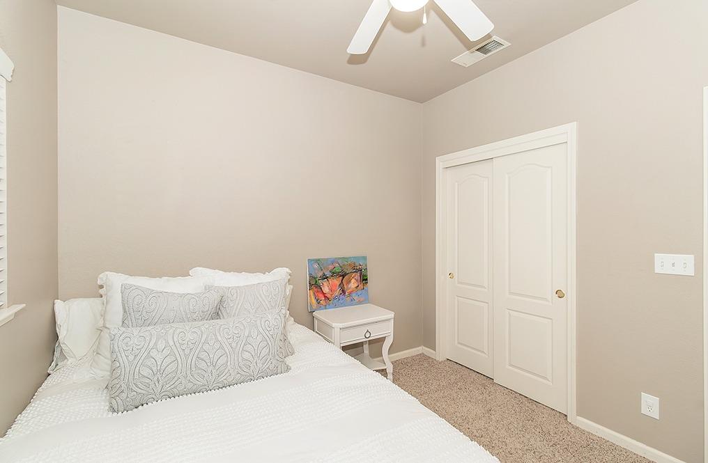 2074 East Revere Road Fresno, CA 93720 - Photo 24 of 39 a bedroom with a bed and a couch