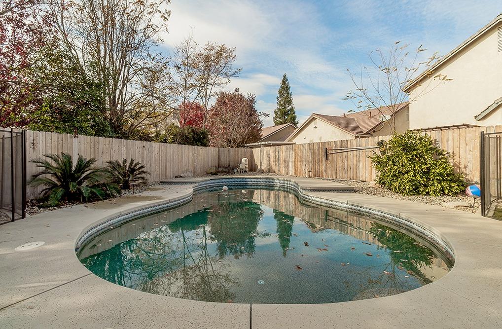 2074 East Revere Road Fresno, CA 93720 - Photo 27 of 39 a view of a swimming pool with a yard