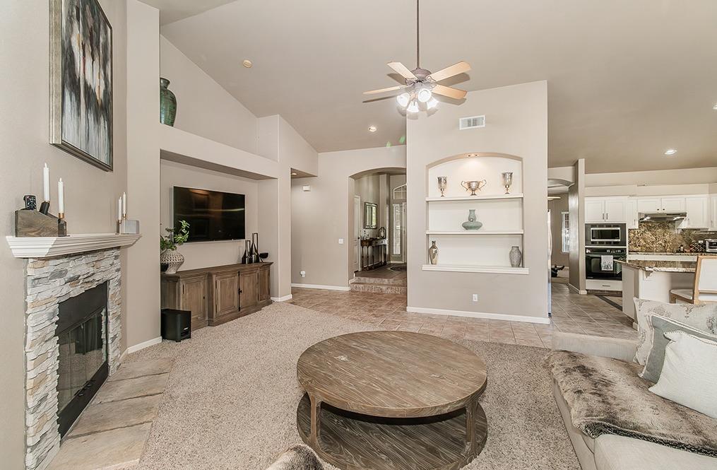 2074 East Revere Road Fresno, CA 93720 - Photo 5 of 39 a living room with furniture and a fireplace