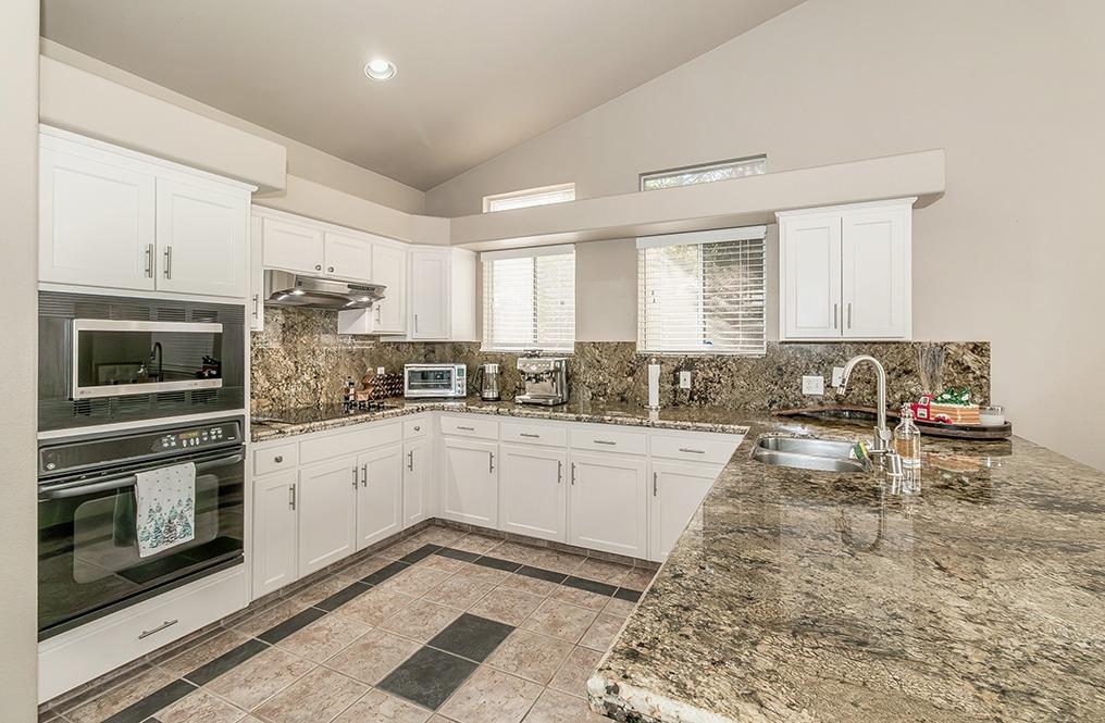 2074 East Revere Road Fresno, CA 93720 - Photo 8 of 39 a kitchen with a stove a sink and a microwave