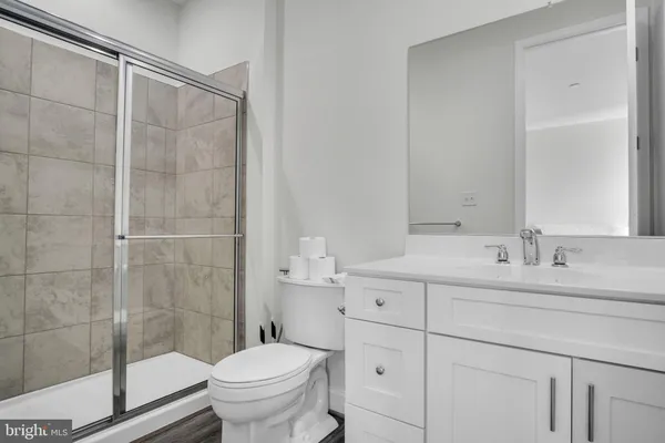 a bathroom with a sink toilet and shower