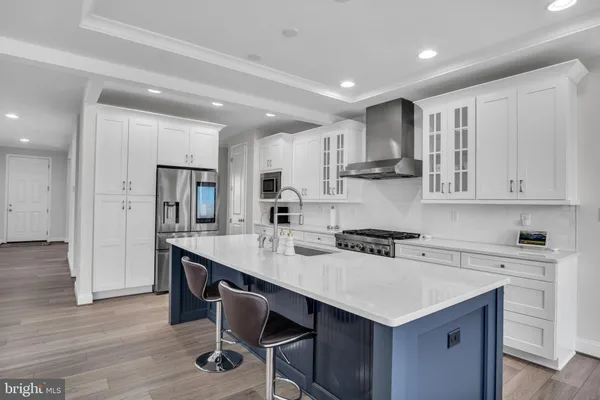 a kitchen with a sink a stove a refrigerator and cabinets