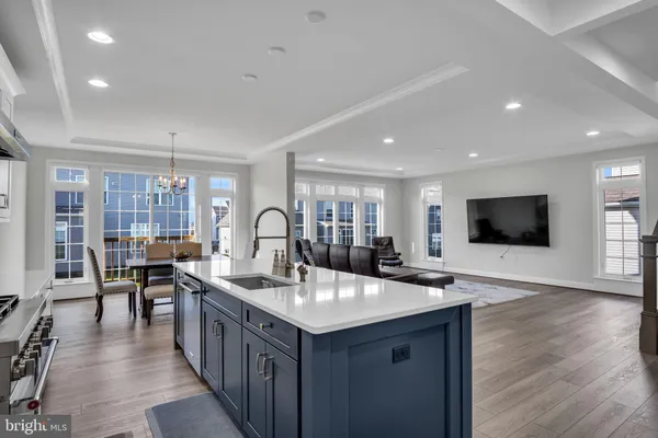 a kitchen with sink and view of living room