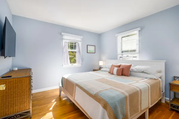 a bedroom with a bed and flat screen tv