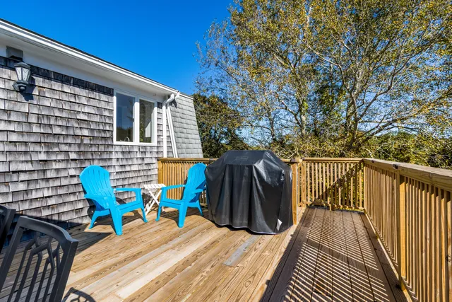 a view of deck with chairs and wooden floor