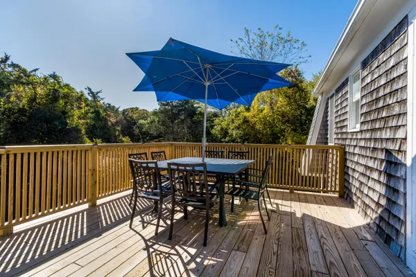 a view of a roof deck with table and chairs