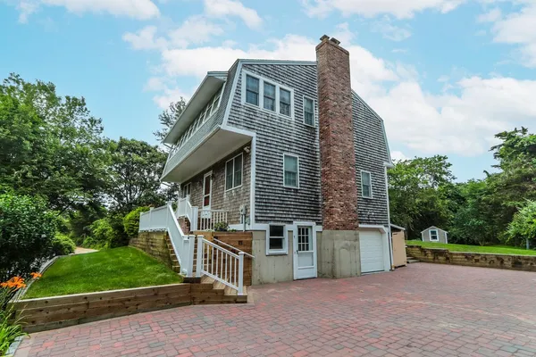 a front view of a house with garden
