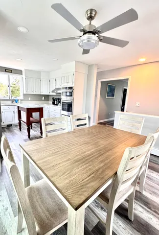 a room with stainless steel appliances kitchen island granite countertop furniture and a kitchen view