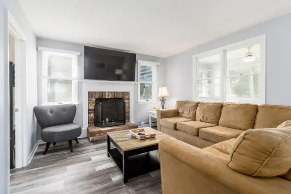 a living room with furniture a flat screen tv and a fireplace