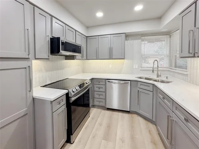 a kitchen with a sink stove and microwave