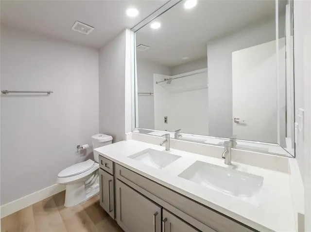 a bathroom with a sink a toilet and a mirror