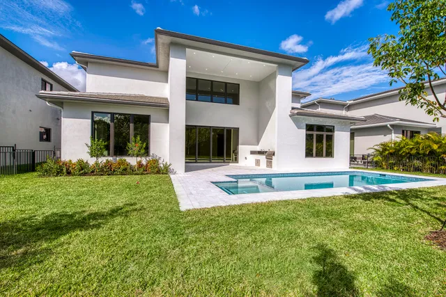 a large kitchen with stainless steel appliances granite countertop a stove a sink and a refrigerator