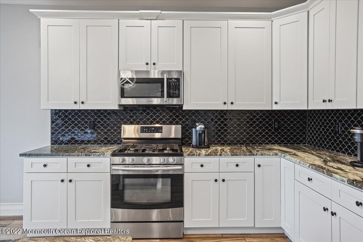 35 Channel Road Toms River, NJ 08753 - Photo 12 of 41 a kitchen with stainless steel appliances granite countertop a stove a sink and white cabinets