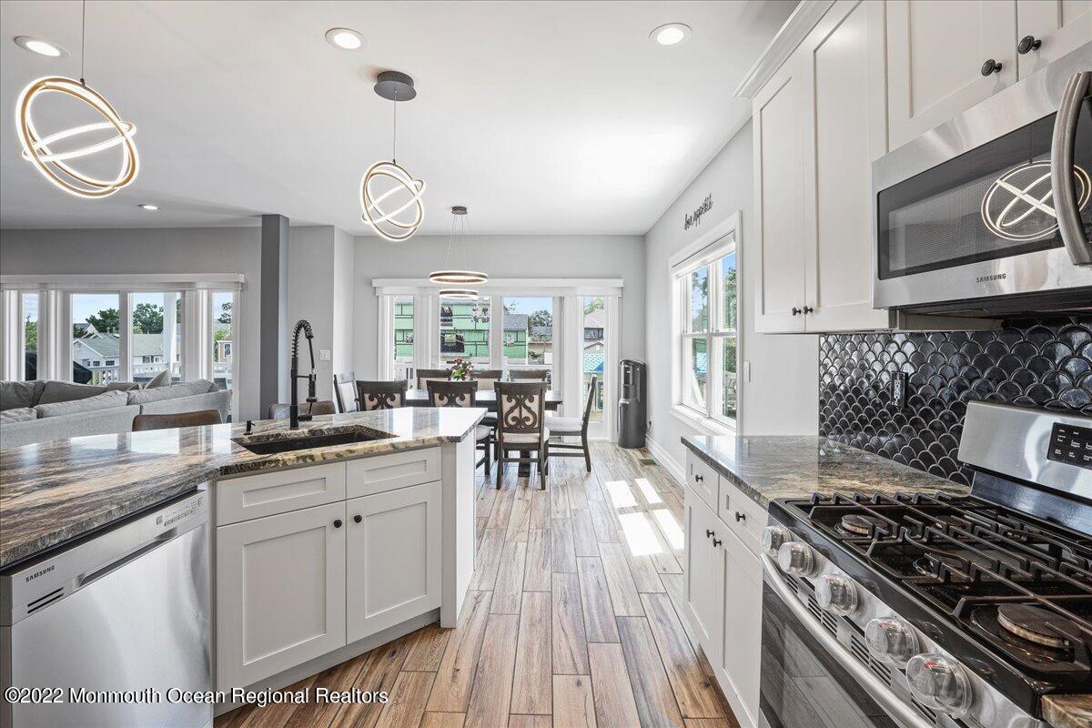 35 Channel Road Toms River, NJ 08753 - Photo 14 of 41 a kitchen with a stove and a white wooden cabinets