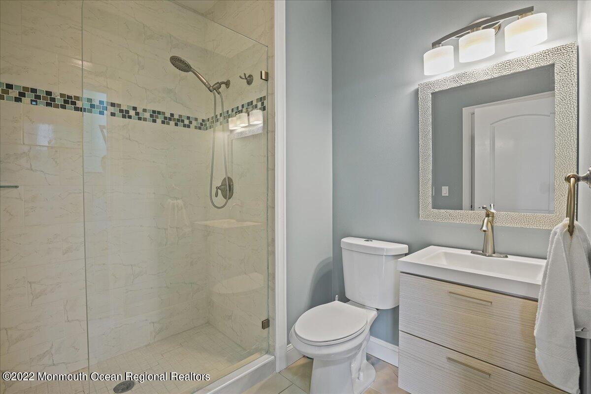 35 Channel Road Toms River, NJ 08753 - Photo 16 of 41 a bathroom with a toilet sink shower and mirror